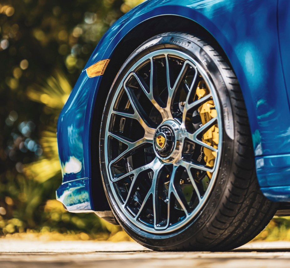 Tire on a blue car, highlighting how tire particles that shed pollute the water and harm the environment