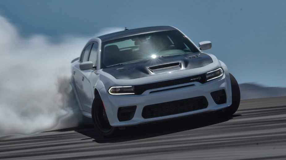 Gas-powered white 2022 Dodge Charger, which will killed to make way for EVs, burning rubber