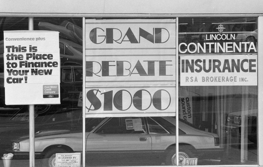 Car finance and lease signs at a Lincoln Continental showroom in 1980
