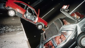Cars on a damaged bridge after an earthquake.