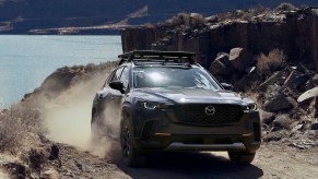 A Mazda CX-50 safety features at work while driving on a dirt road.