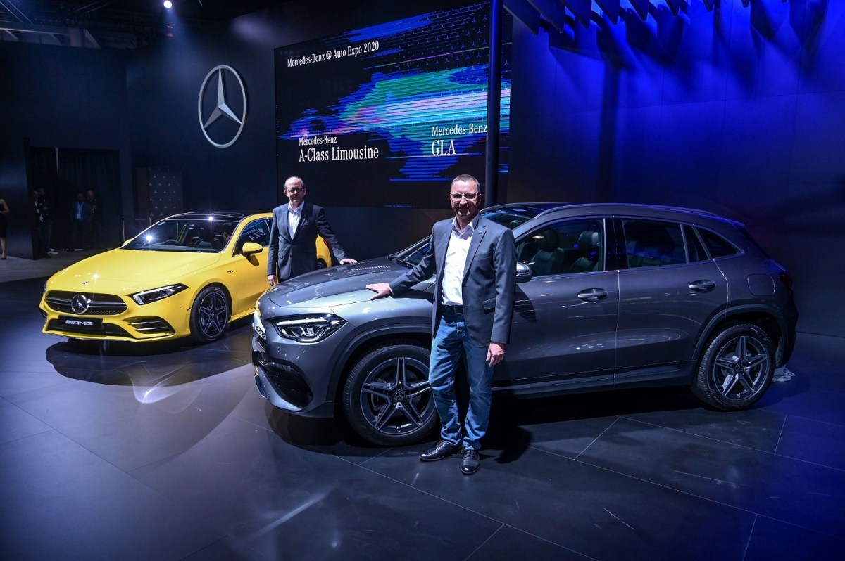 Mercedes GLA and A-Class sedan at an auto show. 
