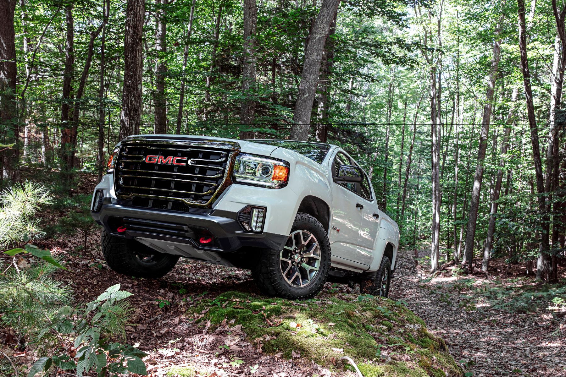 A white 2022 GMC Canyon AT4 midsize truck model is off-road ready. But is it obsolete because of its corporate cousin?