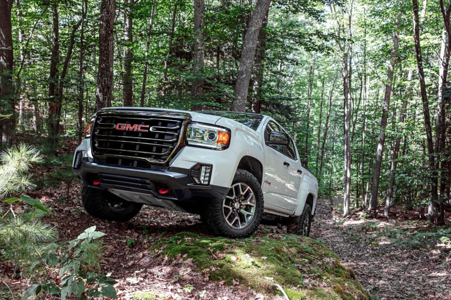 A white 2022 GMC Canyon AT4 midsize truck model is off-road ready. But is it obsolete because of its corporate cousin?