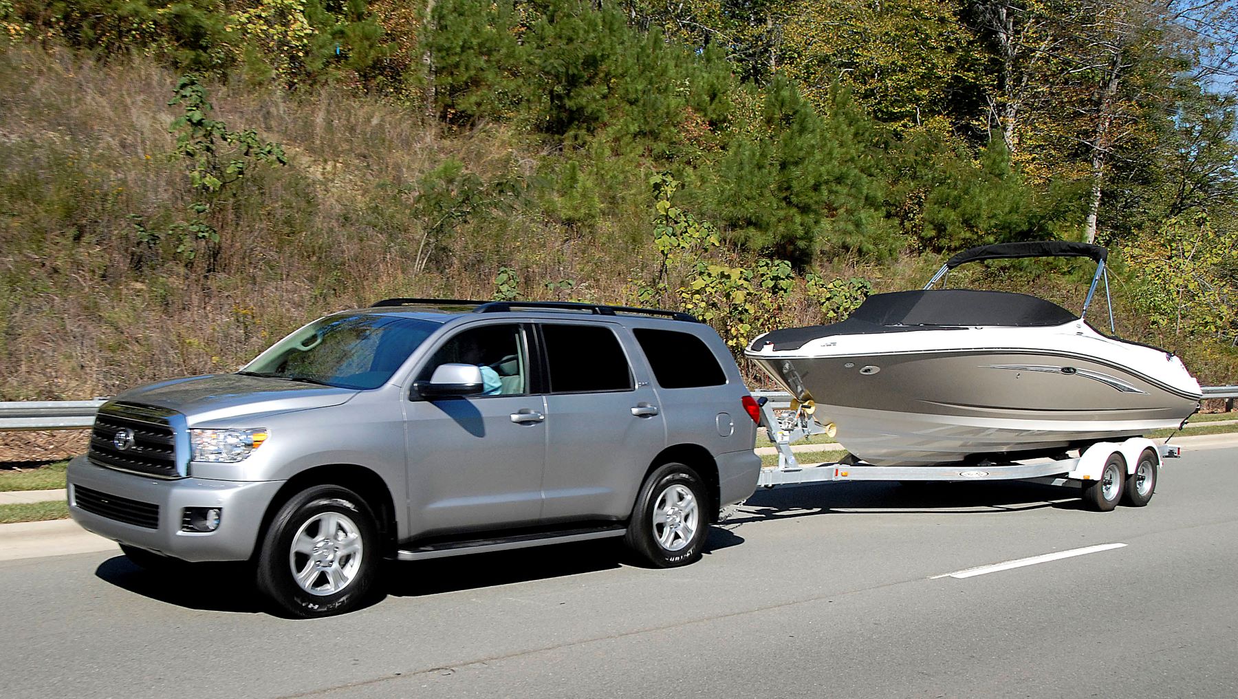 A silver gray 2008 Toyota Sequoia SUV towing a speedboat in Raleigh-Durham, North Carolina