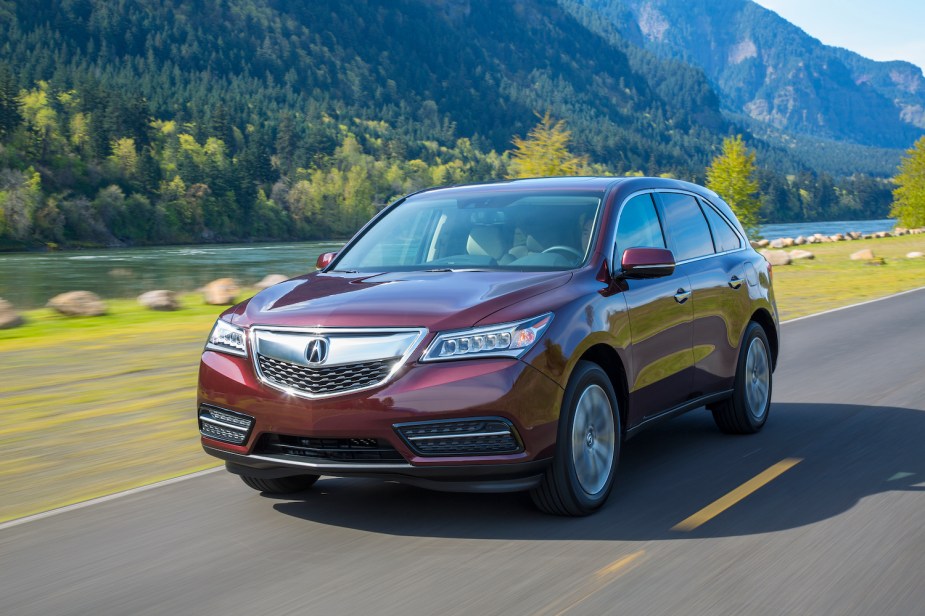 A red 2015 Acura MDX driving, the 2015 Acura MDX is one of the safest used luxury cars for teens