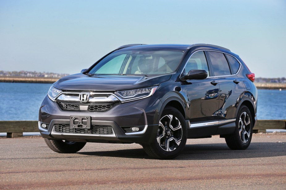 2017 Honda CR V, which is a great used compact SUV, parked in front of a body of water.