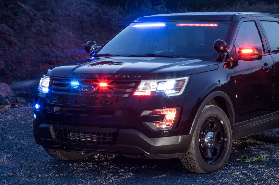Ford's photo of the front of the Police Interceptor Utility SUV with both red and blue lights illuminated and spotlights visible. 