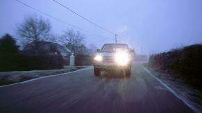 A 2002 Isuzu Trooper Duty with its high beams on, which is a rude gesture on the road