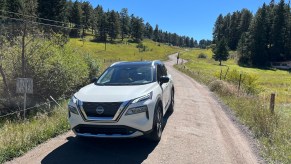 The 2022 Nissan Rogue on a gravel road.