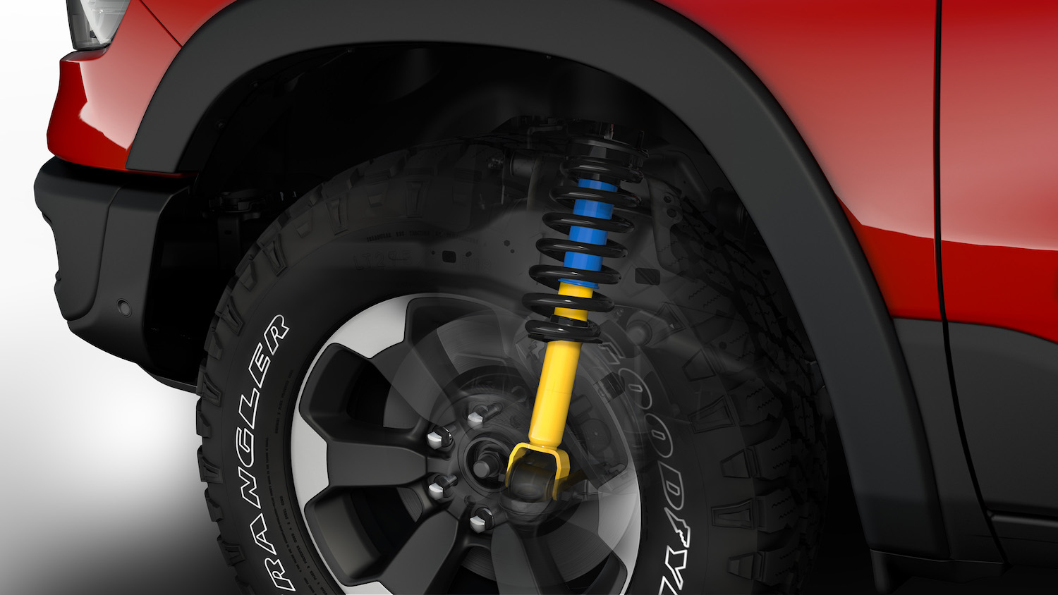 A closeup cutaway of the 2022 Ram 1500 Rebel showing its Bilstein shock absorbers through its front wheels.