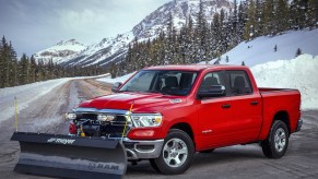 The 2022 Ram 1500 with optional Snow Plow Prep package with snowy mountains nearby