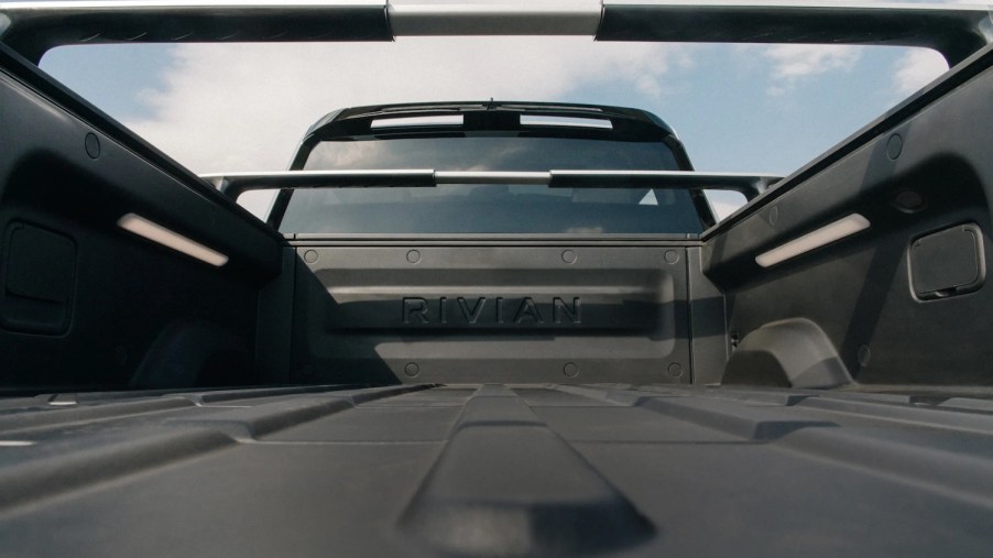 The bed of a Rivian R1T electric pickup truck, complete with outlets.