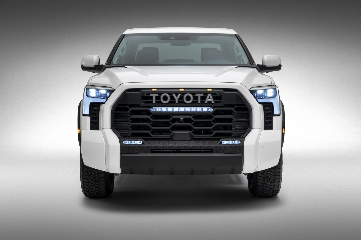 Promo photo of a Toyota Tundra TRD Pro hybrid pickup truck in white, against a white background.