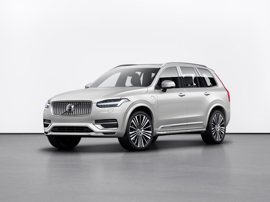 Promo photo of a silver Volvo XC90 midsize SUV with a 3rd row of seating and a plug-in hybrid drivetrain.