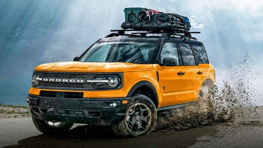 A yellow 2023 Ford Bronco Sport is driving off-road.