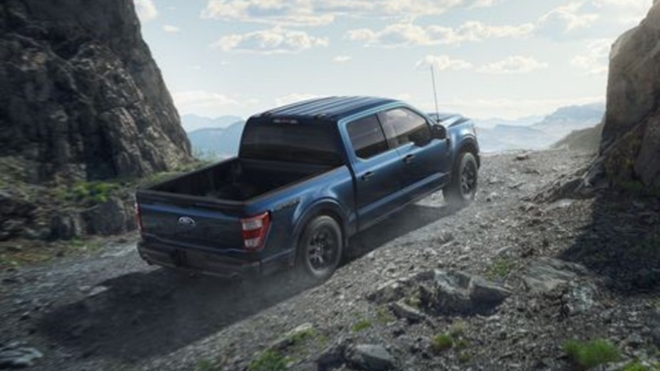 2023 Ford F-150 on a Gravel Trail between two hills
