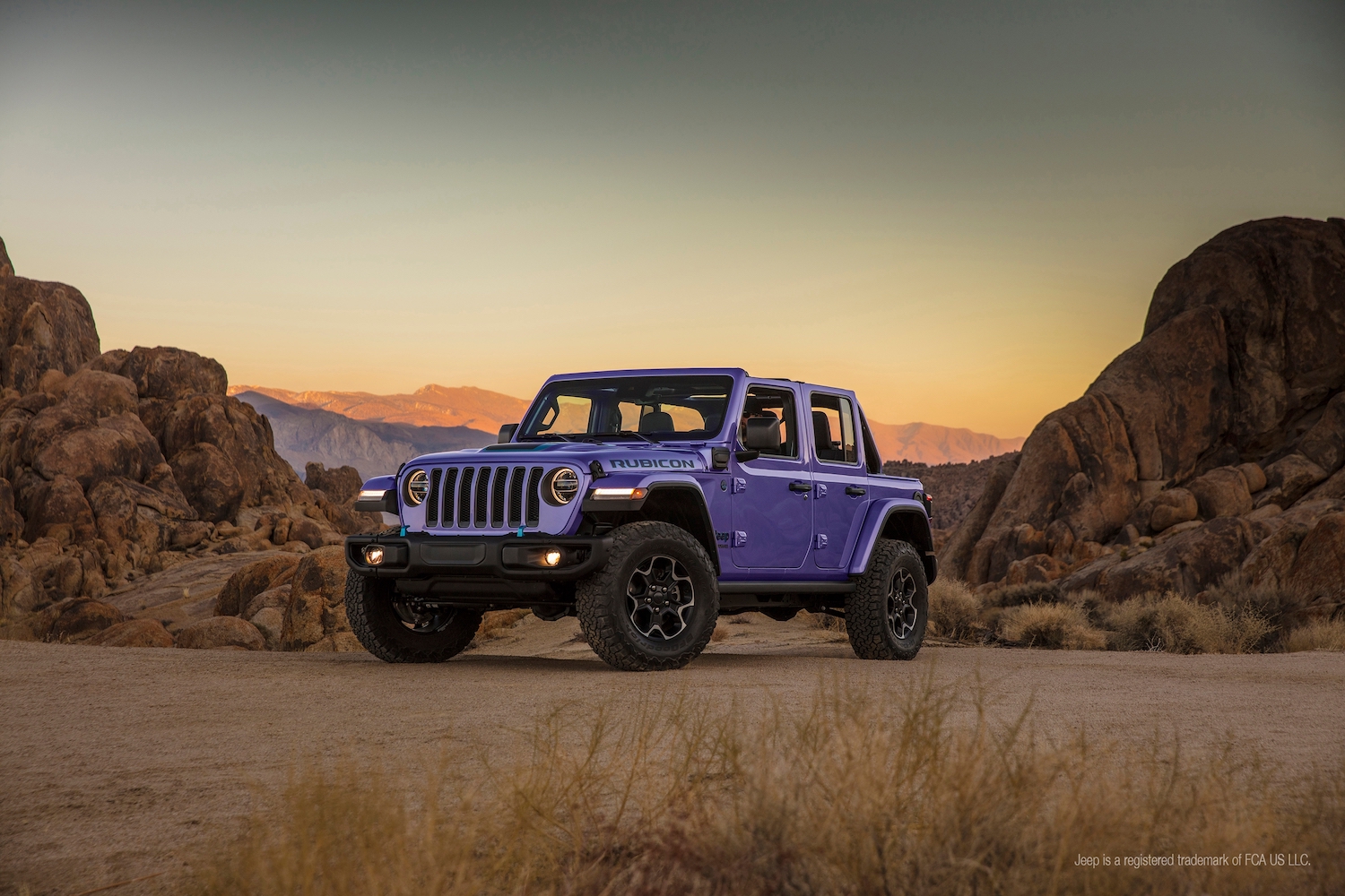 Promo photo of a purple Jeep Wrangler plug-in hybrid SUV parked in teh desert.