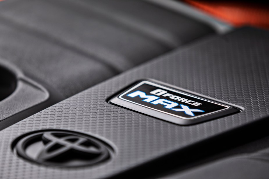 Detail shot of the i-FORCE MAX badge on a 2023 Toyota Sequoia's hybrid engine.