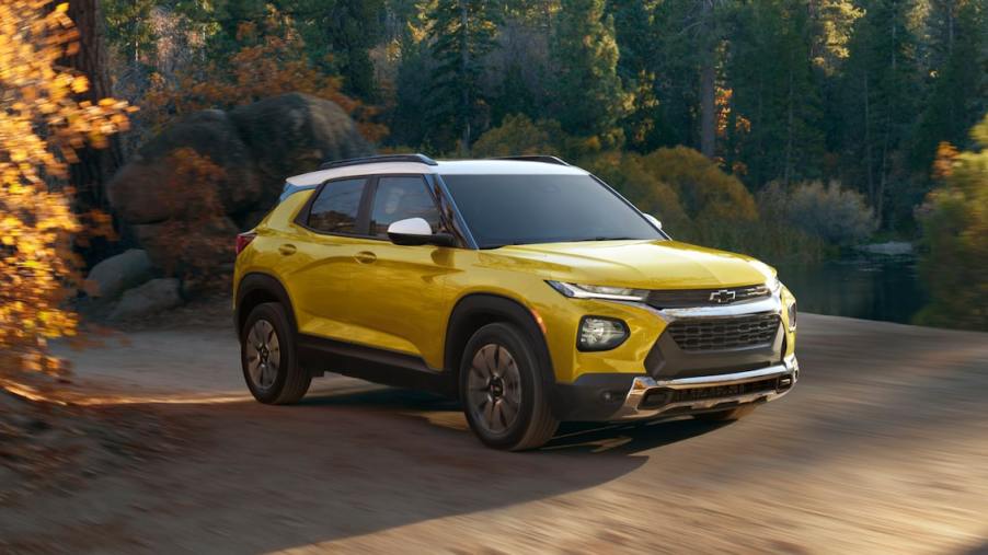 A yellow 2023 Chevy Trailblazer parked outside on a nature trail. Is it bigger than the Chevy Equinox?