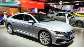 A silver 2023 Volkswagen Arteon parked indoors.