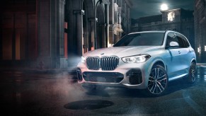 A white 2023 BMW X5 in the city.