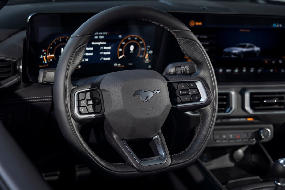 The new Ford Mustang's interior includes a flat-bottom steering wheel and Sync 4..