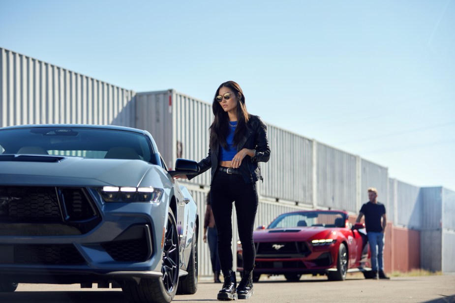 A woman enters a 2024 Ford Mustang.