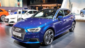 A blue Audi A3 Sportback with adaptive suspension parked indoors.