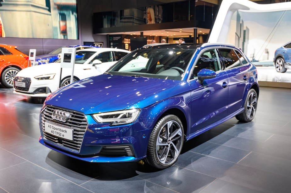 A blue Audi A3 Sportback with adaptive suspension parked indoors. 