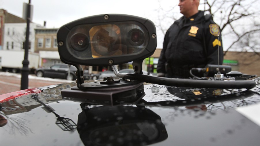 Closeup of an automatic license plate reader scanner camera on the roof of a police SUV.
