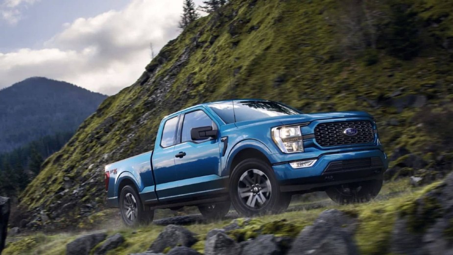 Blue 2022 Ford F-150 Lariat on a mountain road