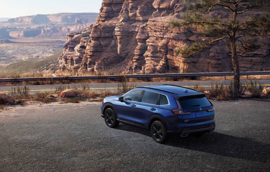 Blue 2023 Honda CR-V Hybrid crossover SUV parked on a scenic overlook