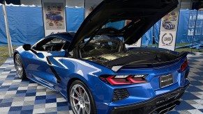 A blue Callaway-modified supercharged C8 Corvette sits with its hood up.