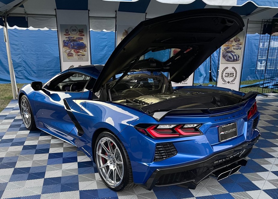 A blue Callaway-modified supercharged C8 Corvette sits with its hood up. 