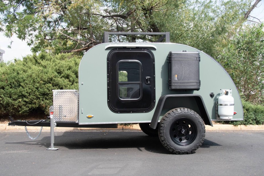 A Colorado teardrop-style camper sits in a parking lot.
