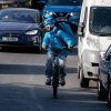 Cyclist riding in heavy traffic, highlighting whether bikes or cars cause mor accidents