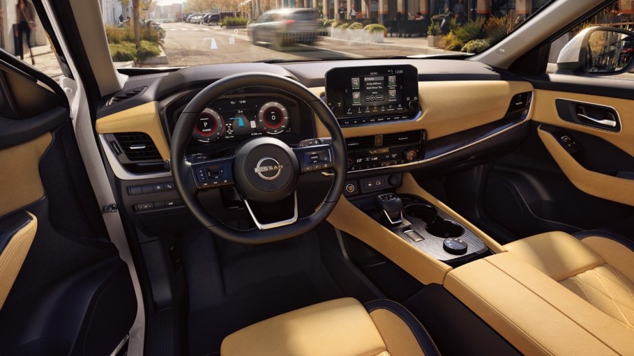 Dashboard and front seats in Front angle view of 2023 Nissan Rogue, highlighting how much a fully loaded one costs