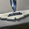 Detail shot of company owner David Brown's name in the hood ornament of a classic Aston Martin sports car.