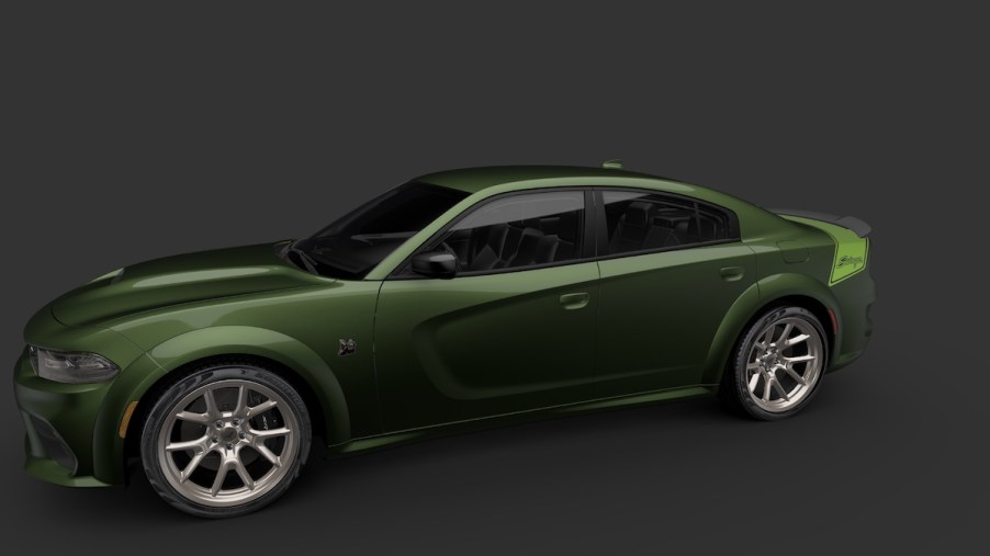 A dark green 2023 Dodge Challenger Last Call Special Edition car against a black background.
