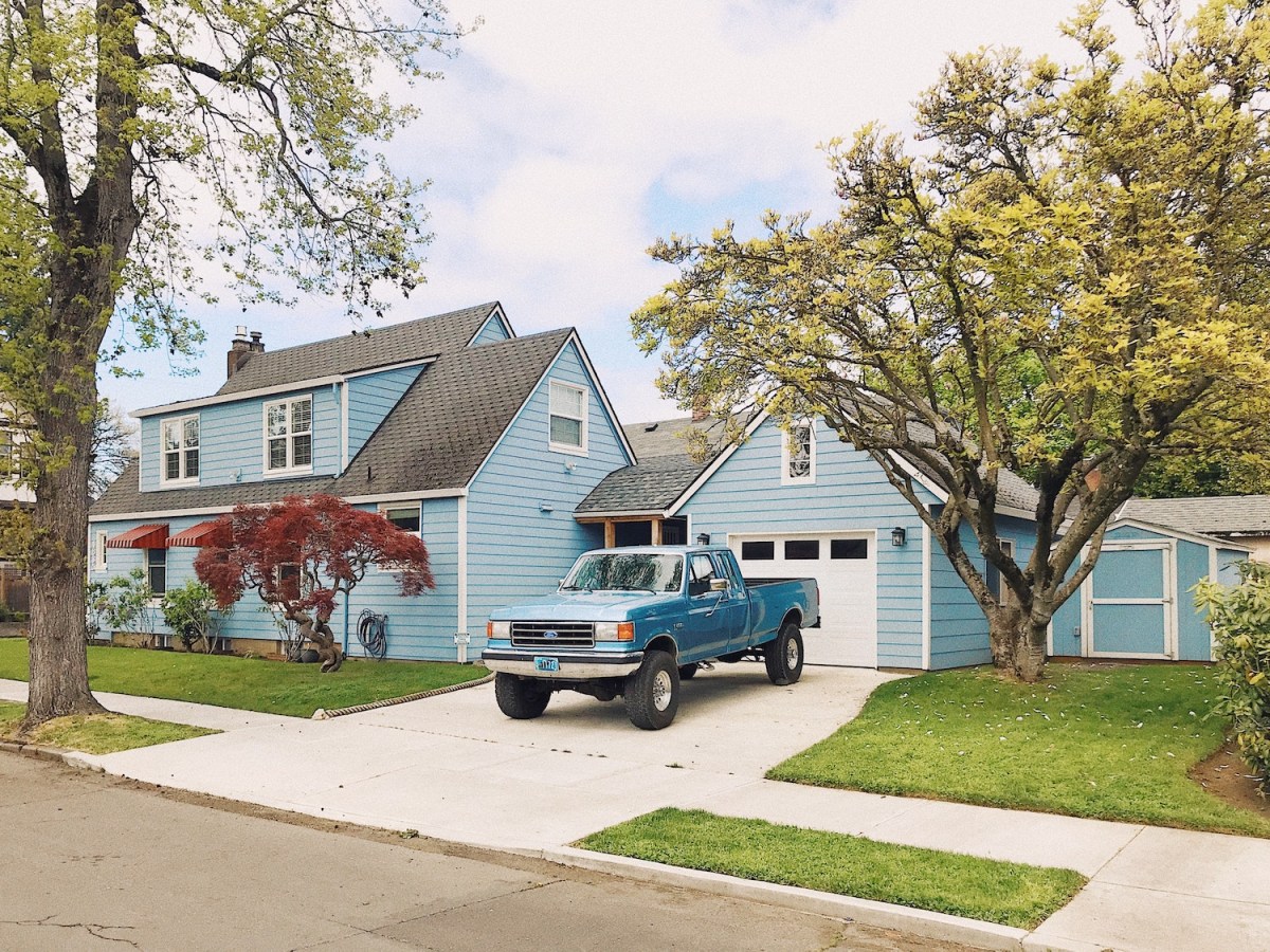 A blue pickup truck parked in a driveway