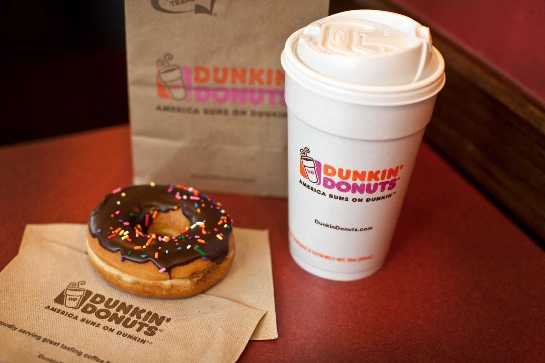 A Dunkin' Donuts donut, coffee, and bag inside a store in West Orange, New Jersey