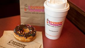 A Dunkin' Donuts donut, coffee, and bag inside a store in West Orange, New Jersey