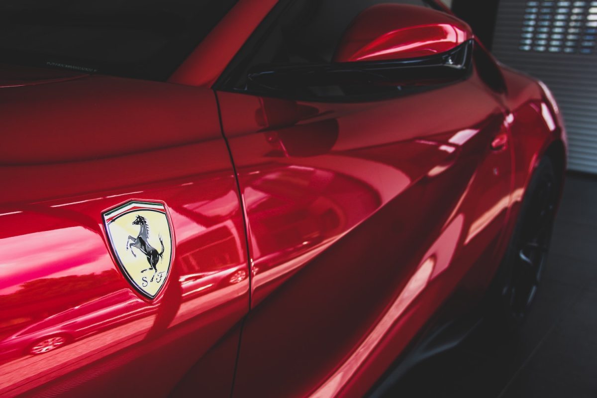The Ferrari logo, a prancing horse, seen on a red Ferrari
