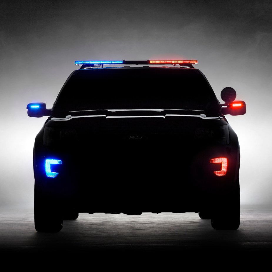 The silhouette of an Explorer-based Ford Interceptor Utility SUV with both its red and blue lights illuminated.