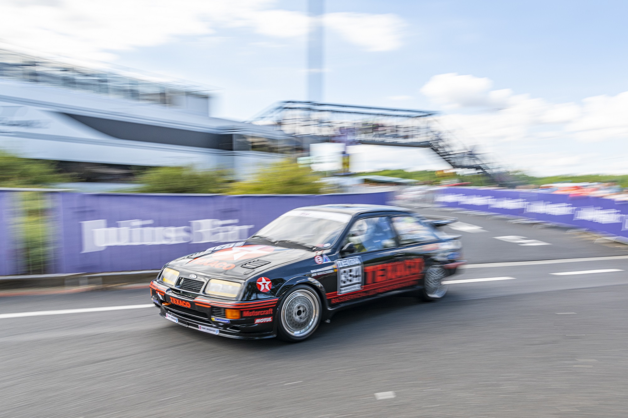The Ford RS500 Sierra Cosworth looks planted on the track.