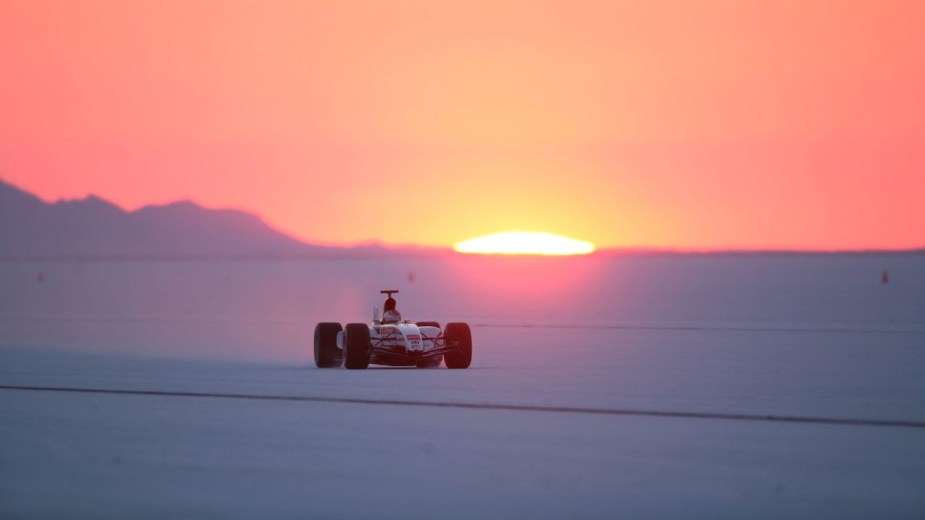 Modified Honda Formula 1 car on the Bonneville salt flats at sunset attempting a world record.