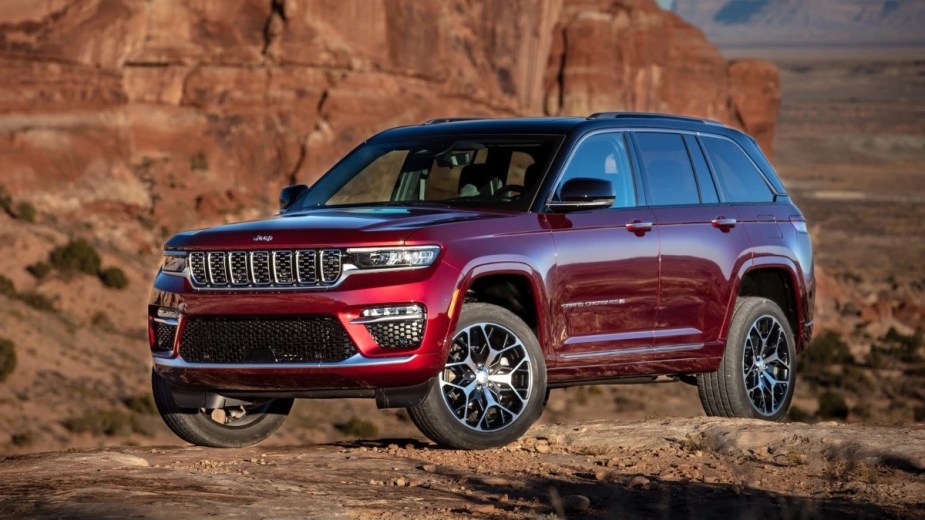 Front angle view of Velvet Red 2023 Jeep Grand Cherokee midsize SUV