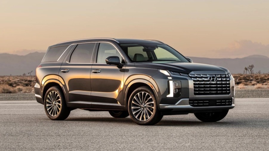 Front angle view of gray 2023 Hyundai Palisade, affordable midsize SUV alternative to Toyota Highlander costing under $36,000