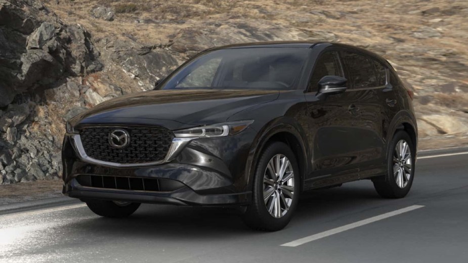 Front angle view of new 2023 Mazda CX-5 crossover SUV with Jet Black Mica exterior paint color option